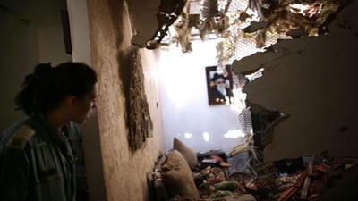 File photo: An Israeli soldier looks at damage in a house in Sderot, Israel (Getty Images: Uriel Sinai)