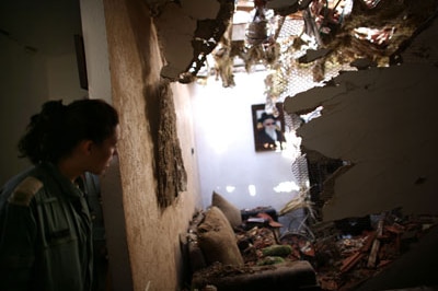 File photo: An Israeli soldier looks at damage in a house in Sderot, Israel (Getty Images: Uriel Sinai)
