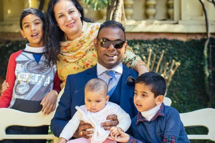 Praveen Kumar with his wife and three children.