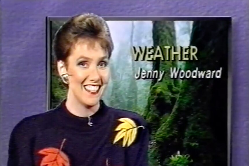 Head shot of woman smiling with words Weather Jenny Woodward on a screen in the background.