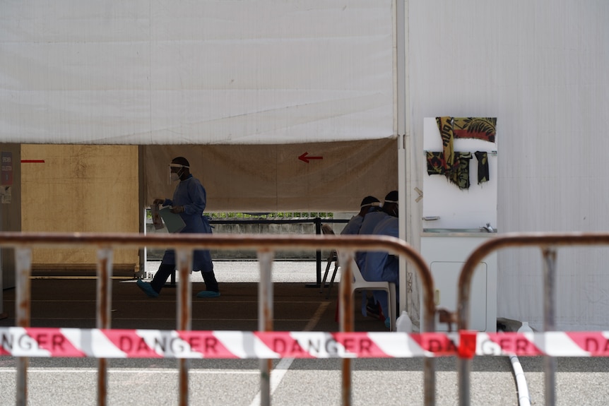 Medical staff standing next to large tents