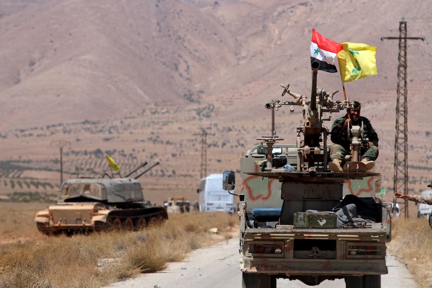 Hezbollah and Syrian flags flutter on a military vehicle in Western Qalamoun, Syria August 28, 2017.