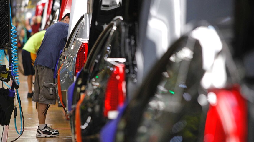 A worker at the General Motors Lansing Grand River Assembly Plant in Michigan assembles vehicles.