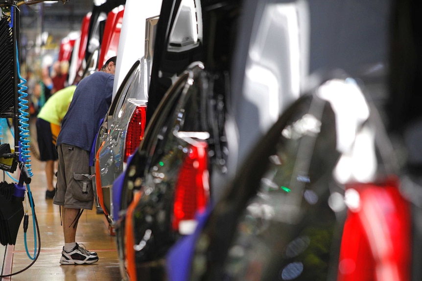 A worker at the General Motors Lansing Grand River Assembly Plant in Michigan assembles vehicles.