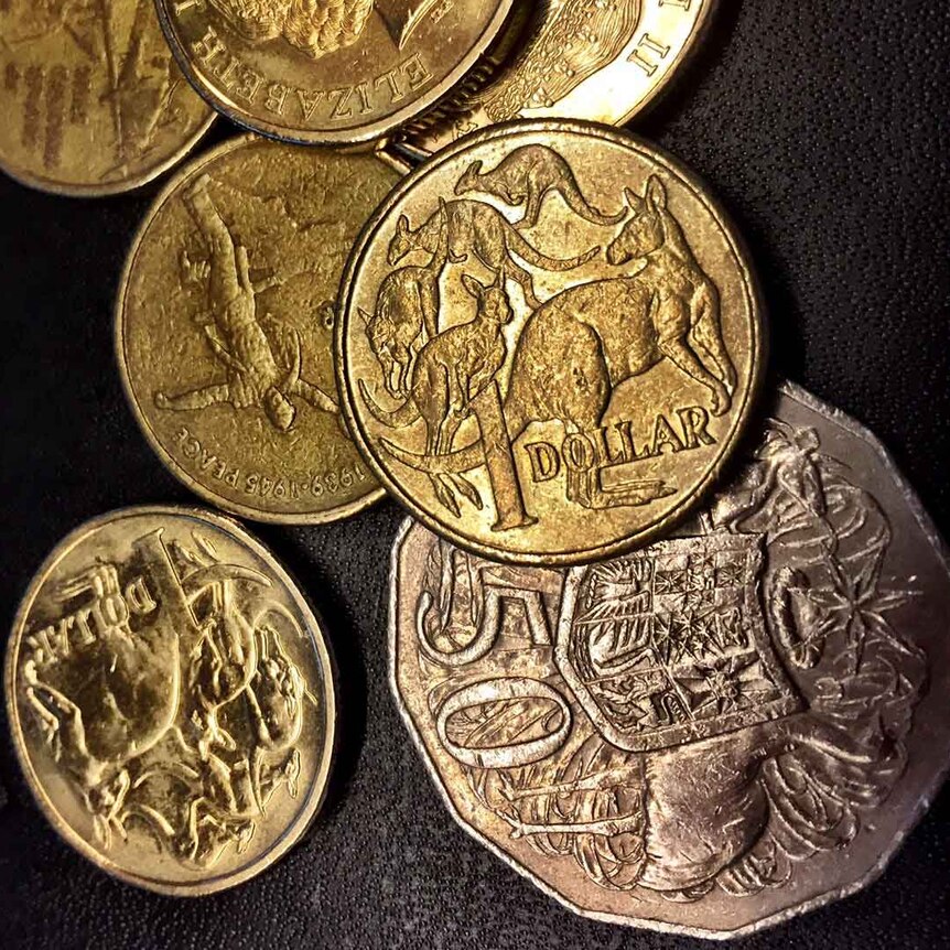 A selection of Australian coins against a black background