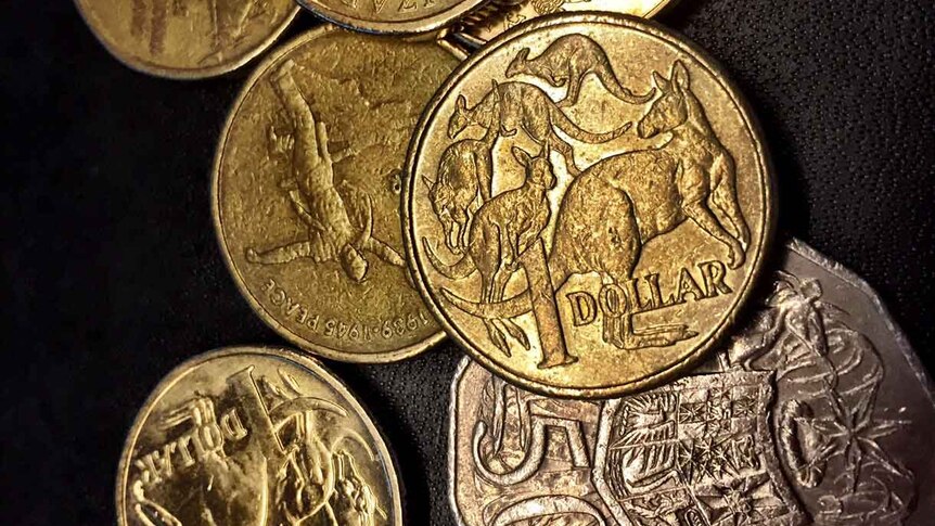 A selection of Australian coins against a black background