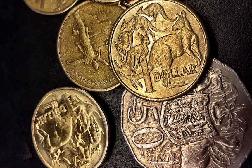 A selection of Australian coins against a black background