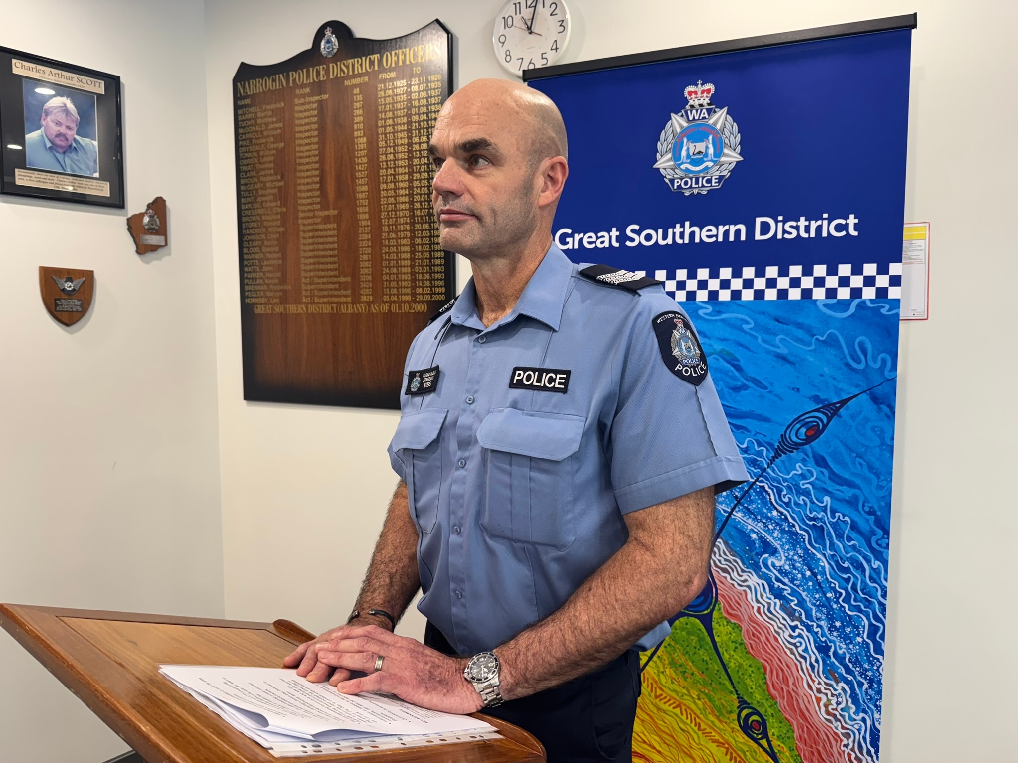 Ένας αστυνομικός με μπλε στολή μιλά στα ΜΜΕ. 