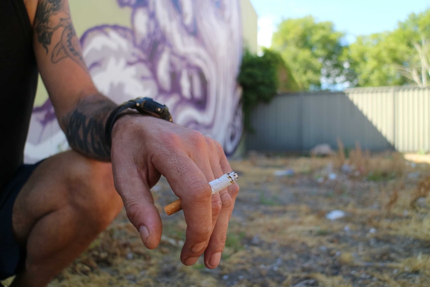 Close of man's hand holding a cigarette