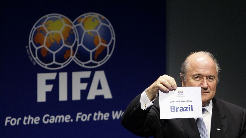 FIFA president Sepp Blatter shows the name of Brazil