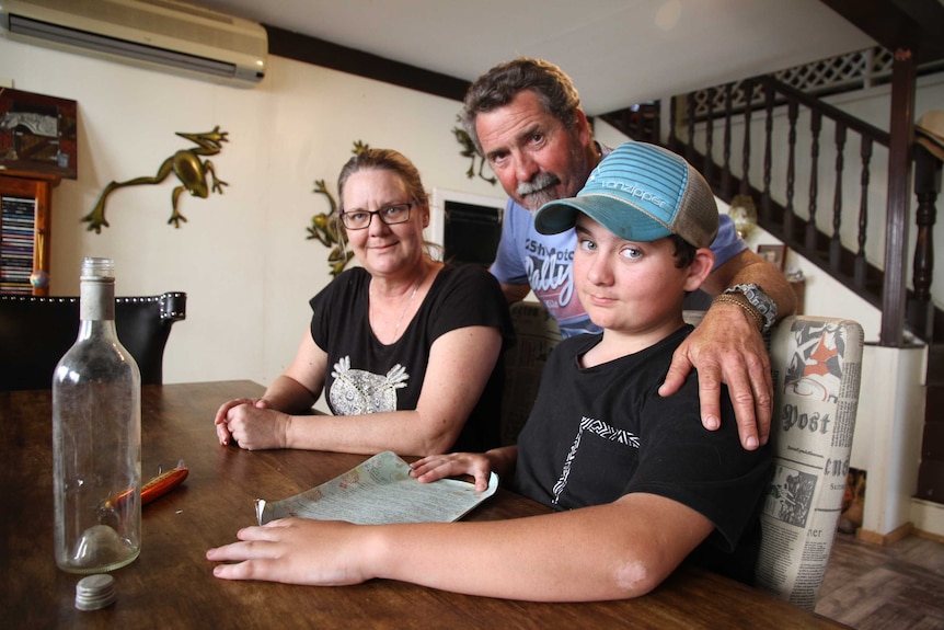 The Knox family with the message they found in a bottle near Keppel Sands.