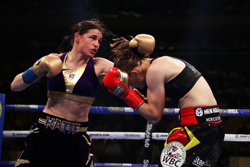 Katie Taylor punches at Delfine Persoon, who ducks
