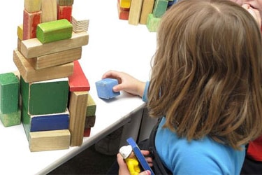 Child playing with blocks at a preschool in Canberra