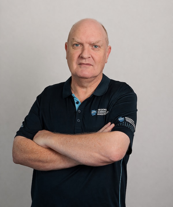 A photo of a man with his arms crossed looking stern.
