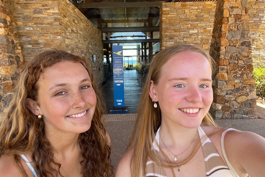 Ruby Smith and Greta Lynch standing outside the resort, smiling.