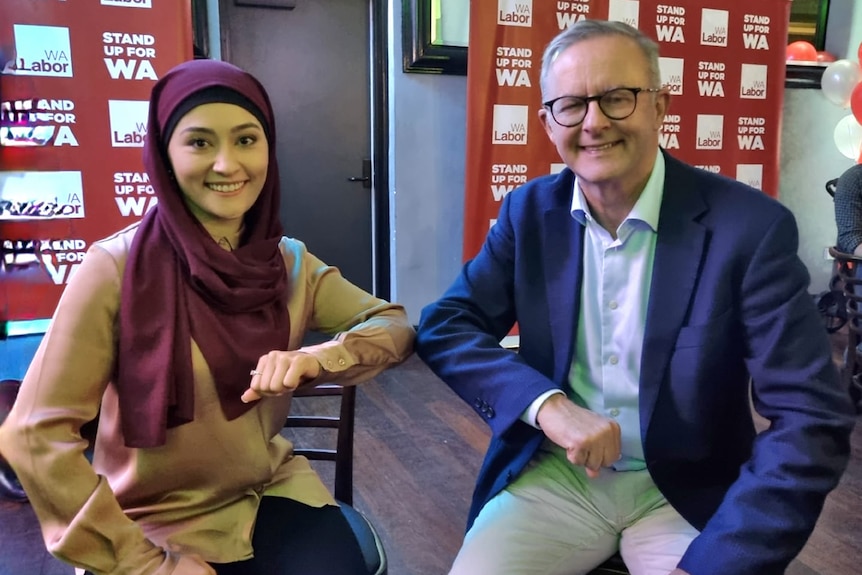 Payman and Albanese bump elbows in a 'COVID-safe handshake' as they pose for a picture.