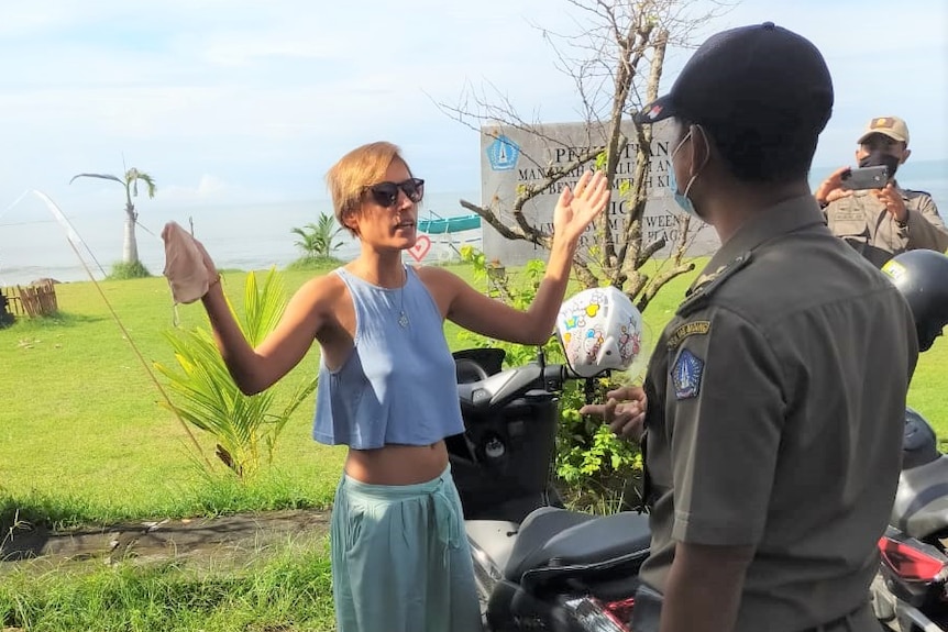 A woman not wearing mask shrugged her shoulders when questioned by the public order agency officer.