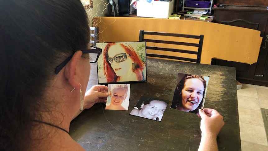 Callie Westbrook looks at smiling photos of herself before she lost her teeth.