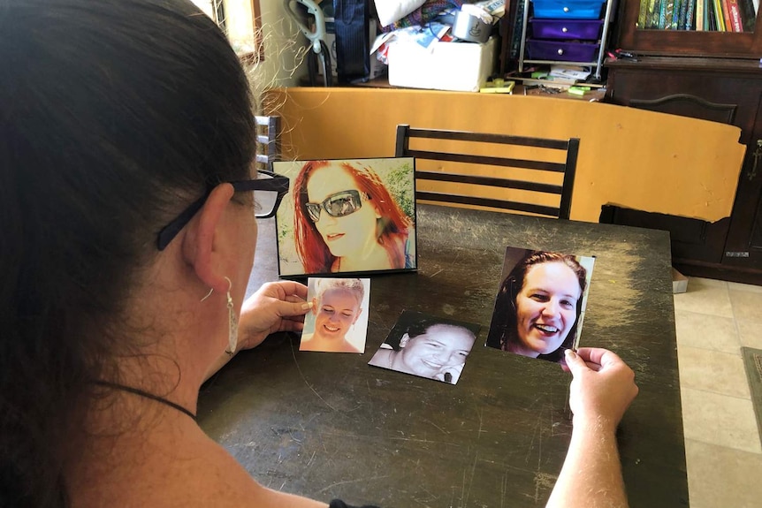 Callie Westbrook looks at smiling photos of herself before she lost her teeth.