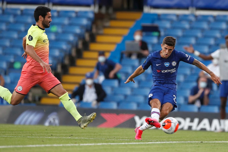 El futbolista de la Premier League mira el balón cuando lo golpea en la red para un gol (no se muestra el portero).