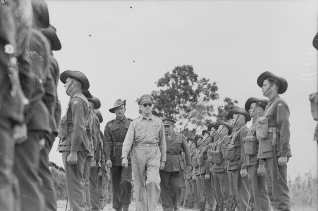 General Douglas MacArthur (in the centre) inspecting the guard of honour comprising units of the 26th Australian Infantry Brigade of the 9th Australian Division