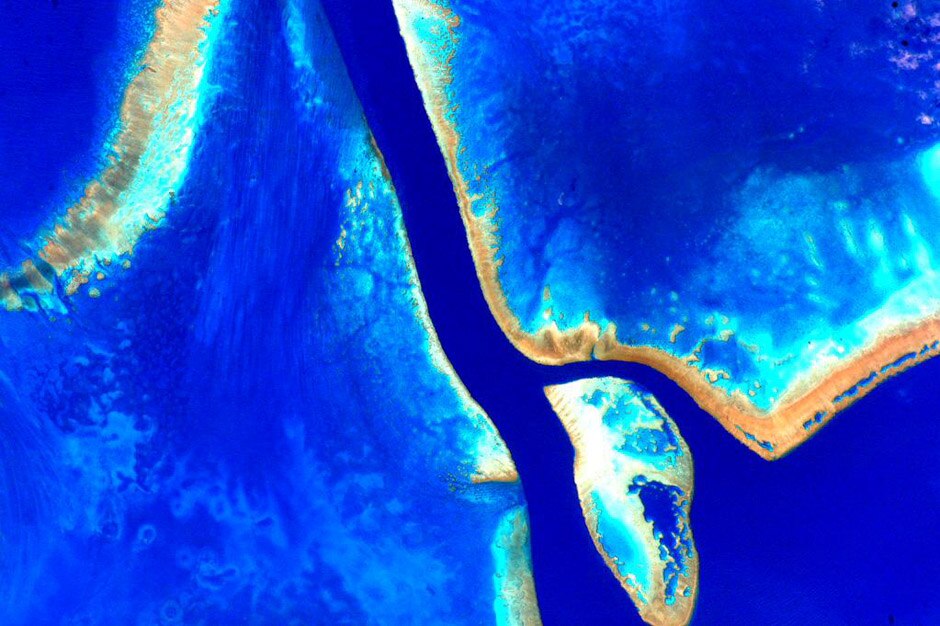 A vibrant colour-enhanced photo the Great Barrier Reef taken from space by astronaut Scott Kelly.