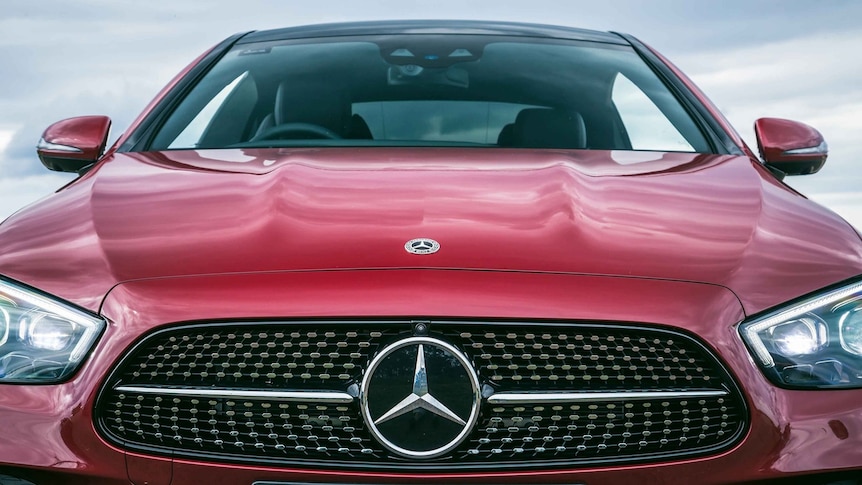 A red Mercedes-Benz car, shown from the front.