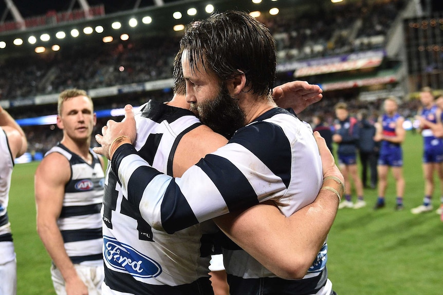 Corey Enright (left) and Jimmy Bartel of the Cats