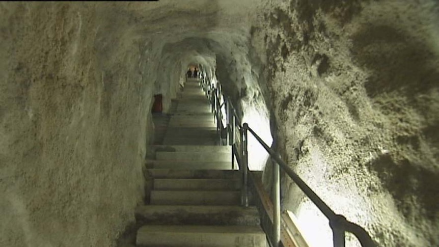 Five flights of stairs lead down to a cellar deep inside a cliff near Hobart.