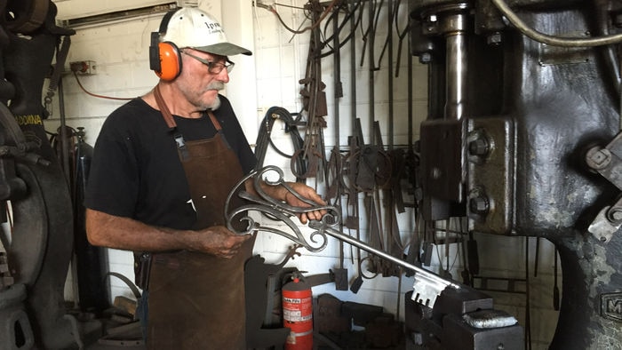Gus Peterson in his workshop making a giant key.