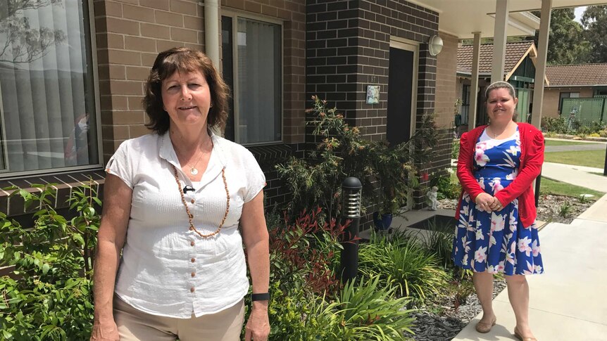 Christine and Narelle Harrington stand outside their units