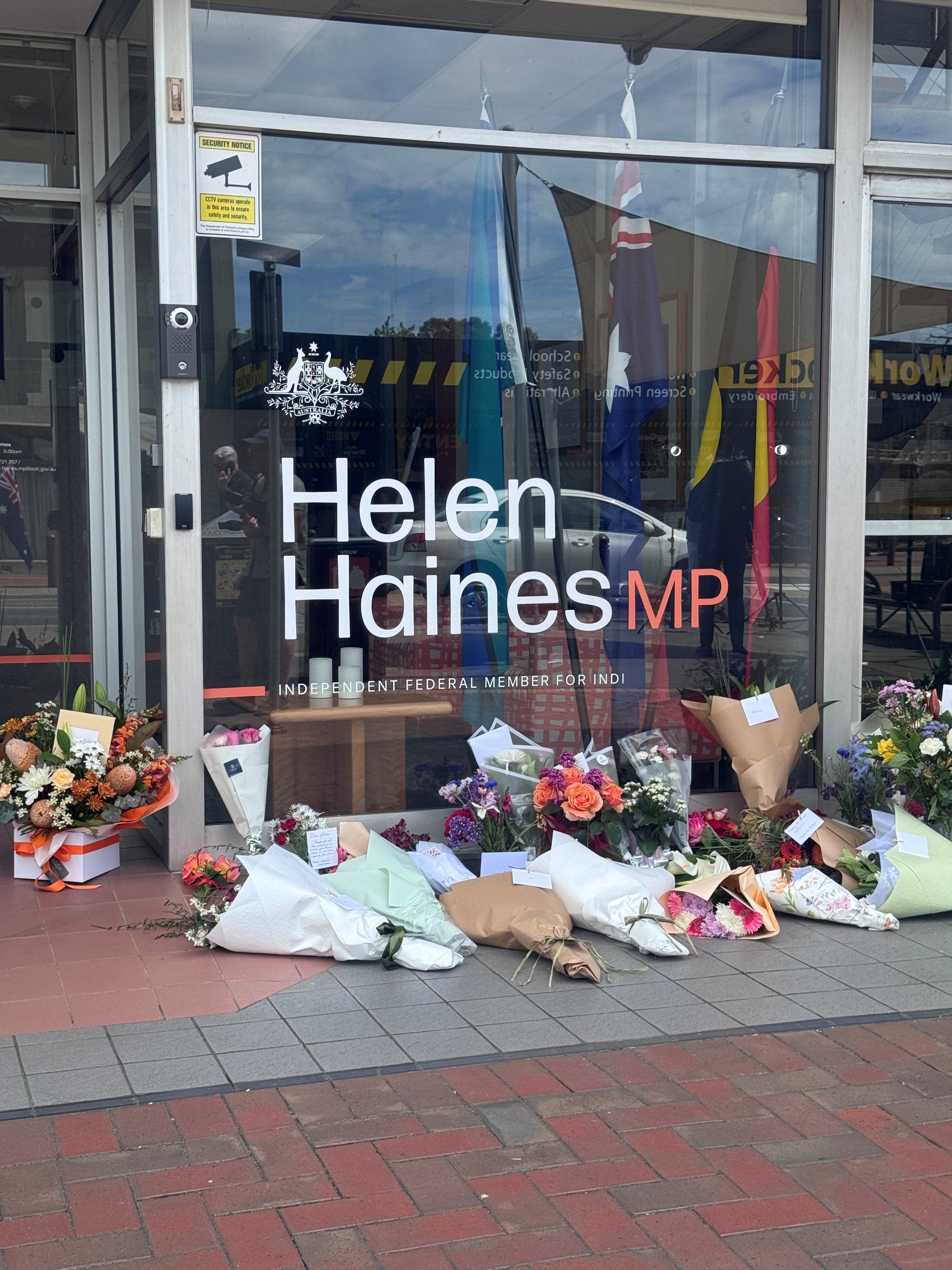 Flowers lay outside an office.