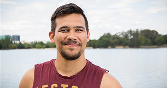 Image of Sean Bhar-Kelly standing in front of a lake.