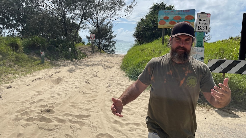 Man gestures at a beach access ramp.