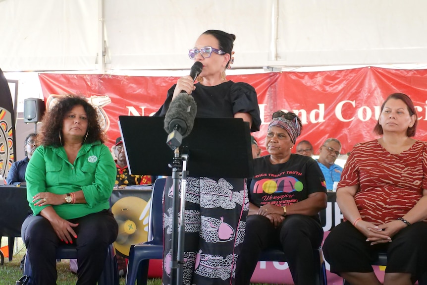 Indigenous Australians Minister Linda Burney standing on stage and speaking into a microphone.