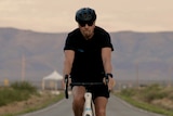 Sir Richard Branson on a bicycle.