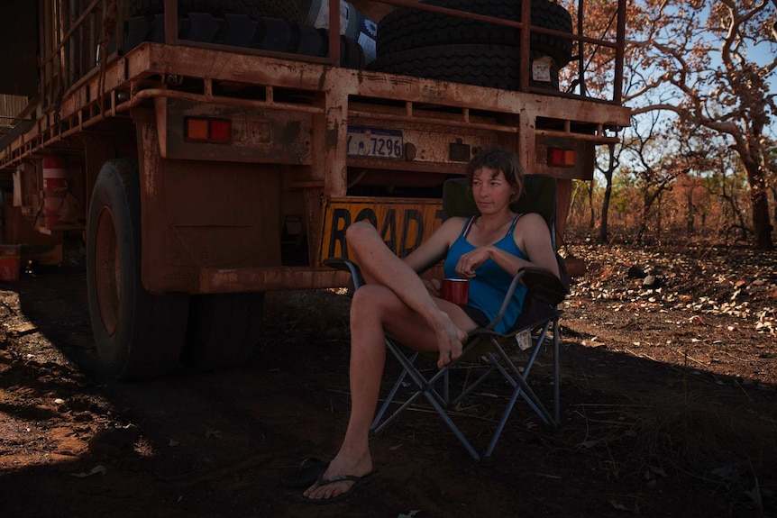 Joanna seeks refuge from the midday sun at the back of the truck, but there’s no escaping the flies