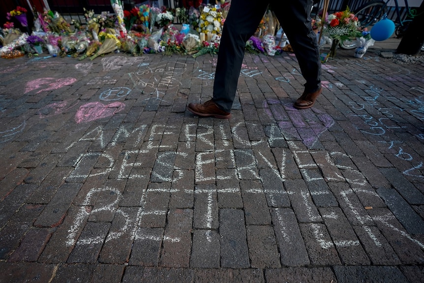 A man walks past a memorial for those killed in a mass shooting in Dayton, Ohio, US August 7, 2019.