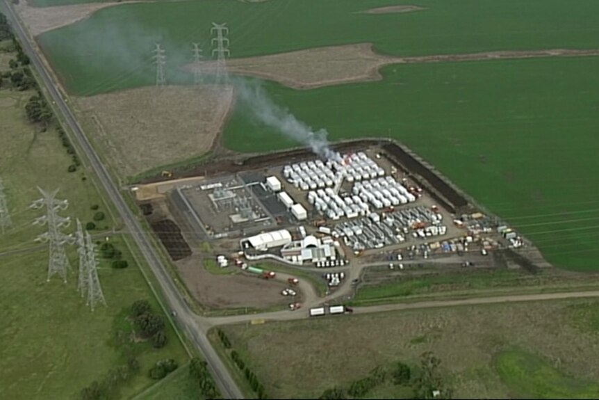 An aerial photo showing an industrial site with a small plume of smoke.
