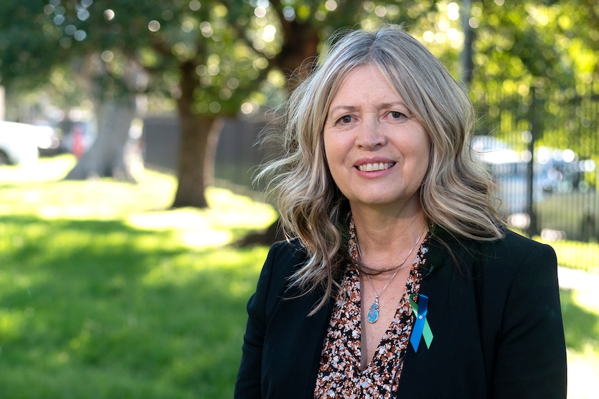 A woman pictured outdoors during a TV interview