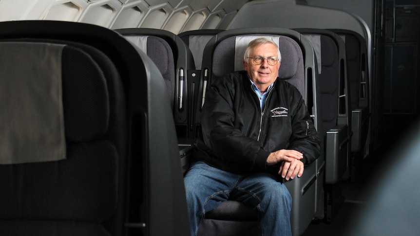 A man sitting in an aircraft seat