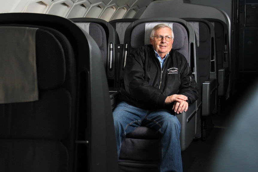 A man sitting in an aircraft seat.