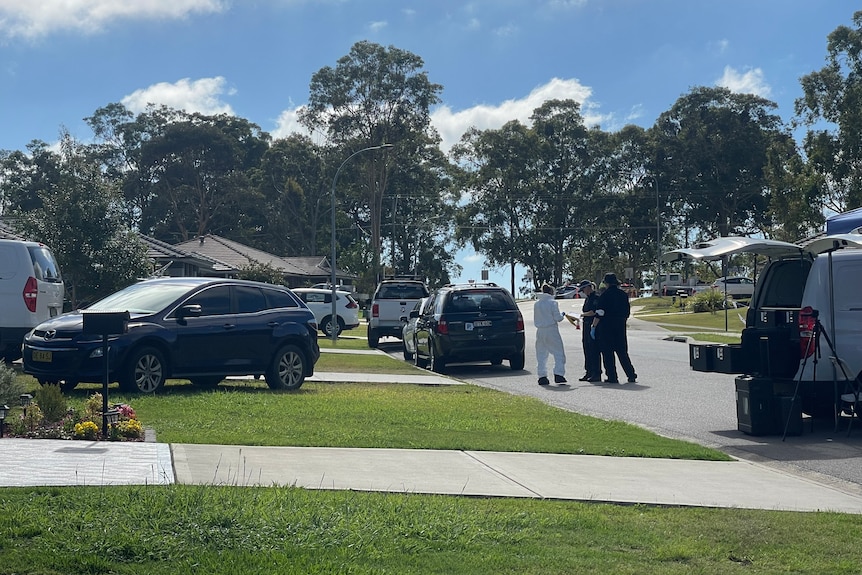 forensic police car and officers on a residential street