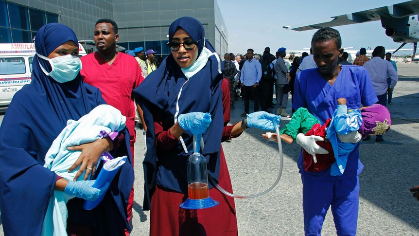 Medical personnel carry wounded children to be airlifted to the Turkish capital for treatment.