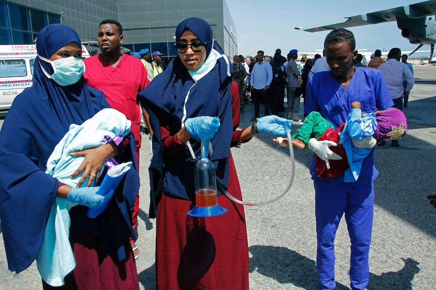 Medical personnel carry wounded children to be airlifted to the Turkish capital for treatment.