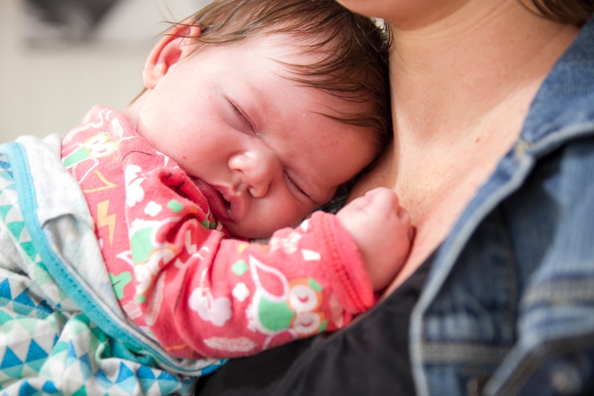 Baby asleep on mother's shoulder