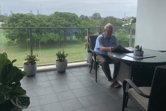 Sir Leo Hielscher sitting on the balcony of his apartment in Yeronga in Brisbane.