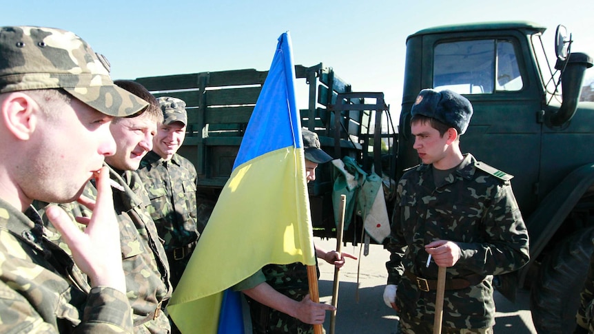 Ukrainian servicemen gather at a military base in the Crimean town of Belbek