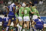 Canberra players celebrate one of the team's six tries against the Bulldogs.