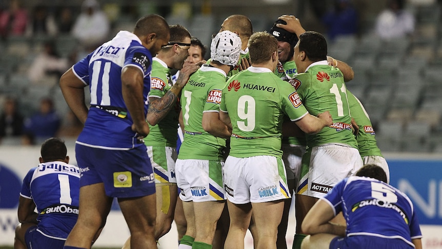 Canberra players celebrate one of the team's six tries against the Bulldogs.